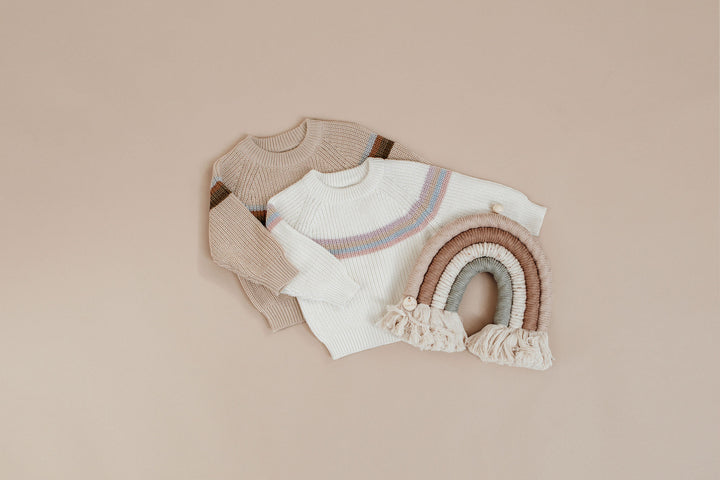 Flat lay composition with cute baby knitwear for photoshoot 