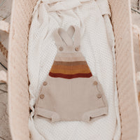 Aster & Oak Organic Cotton Neutral Rainbow Knit Romper Flatlay on Beach