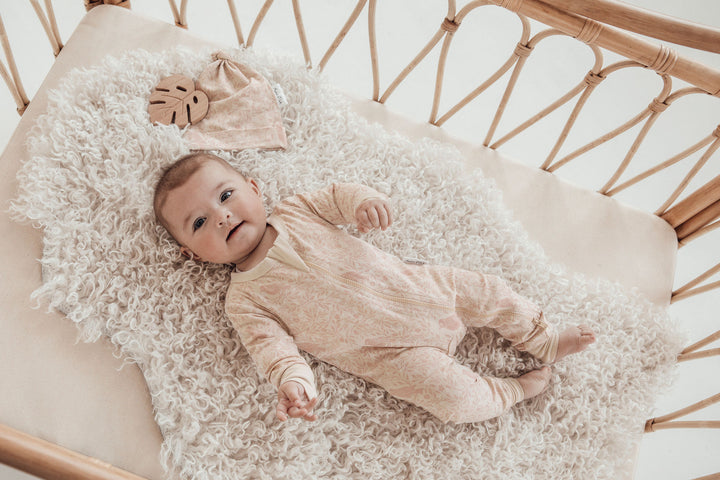 Baby clothes for newborn on grey blanket